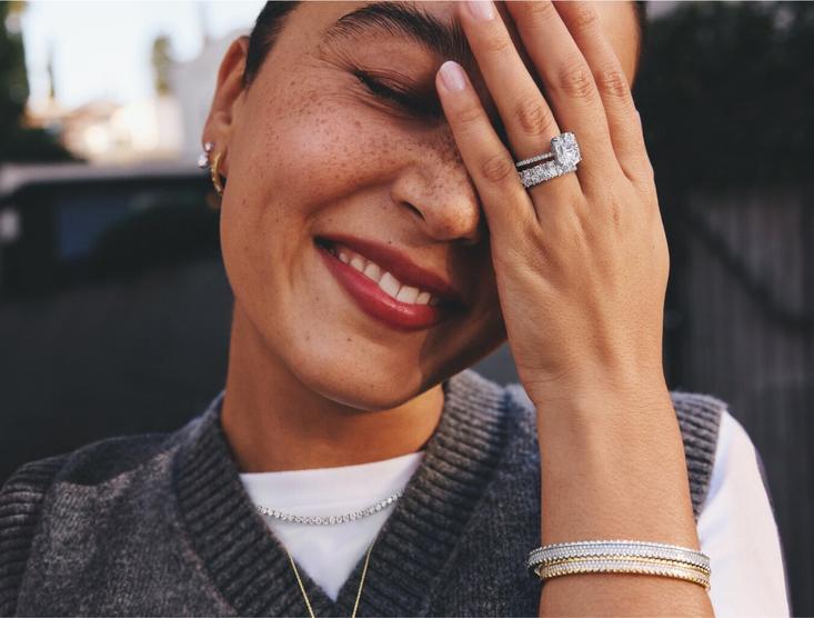 Model wearing an assortment of fine jewelry in a variety of different price points 