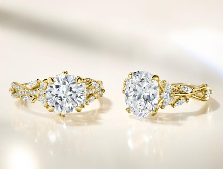 Two yellow gold lab diamond engagement rings.