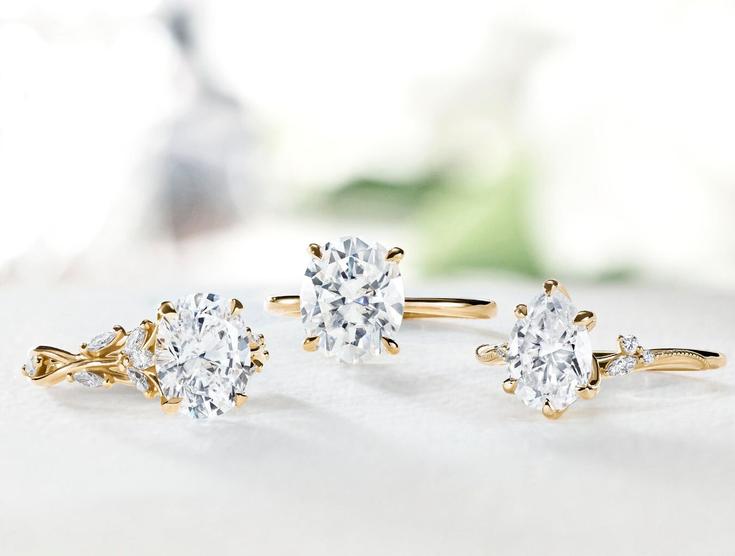 Assortment of yellow gold lab diamond engagement rings.