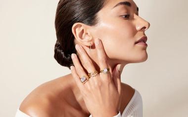 Model wearing an assortment of yellow gold rings