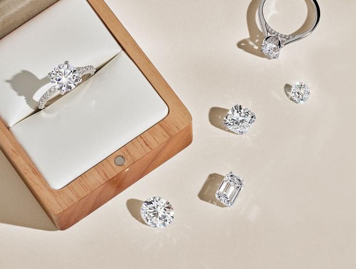 Diamond engagement rings and assortment of loose diamonds.